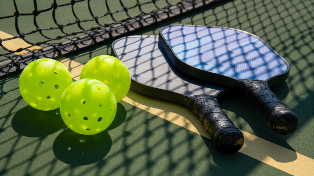 Pickleball, Two Paddles, and net on Pickleball Court